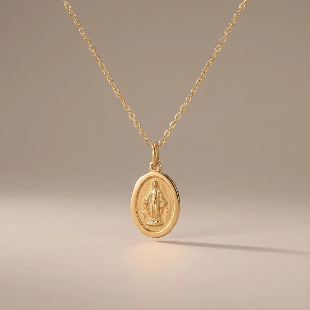 Our Lady Watches, a sealed 18K gold Our Lady medal necklace, on a plain background