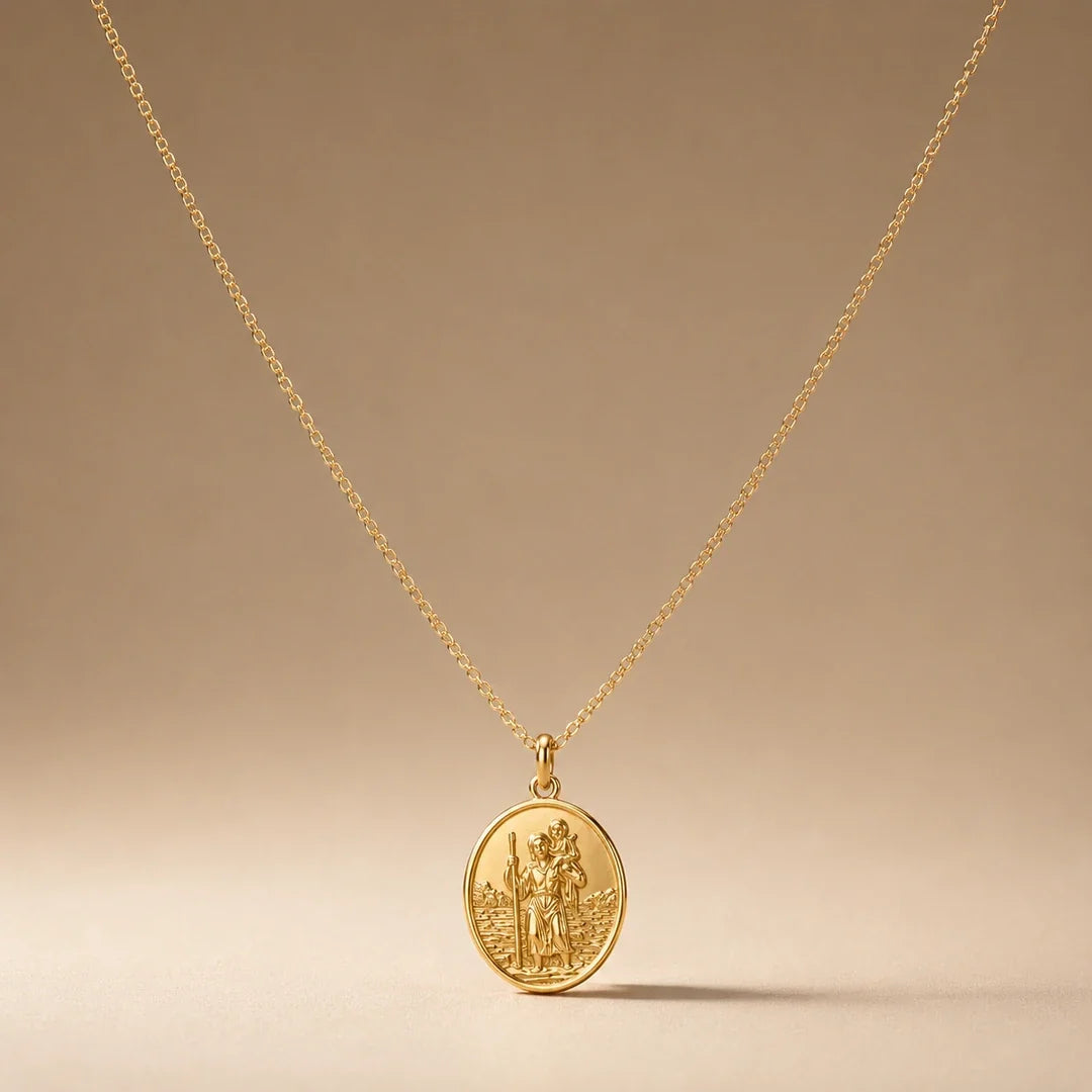 Safe Travels, a sealed 18K gold St. Christopher medal necklace, on a plain background