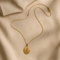 Safe Travels, a sealed 18K gold St. Christopher medal necklace, a keepsake gift for safe travels