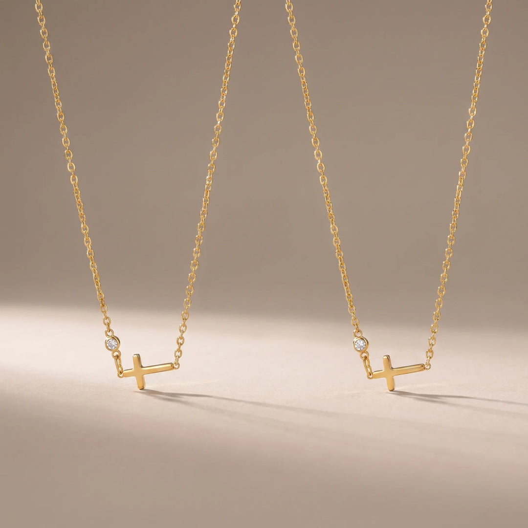 Sisters, two matching sealed 18K gold necklaces, on a plain background