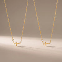Sisters, two matching sealed 18K gold necklaces, on a plain background