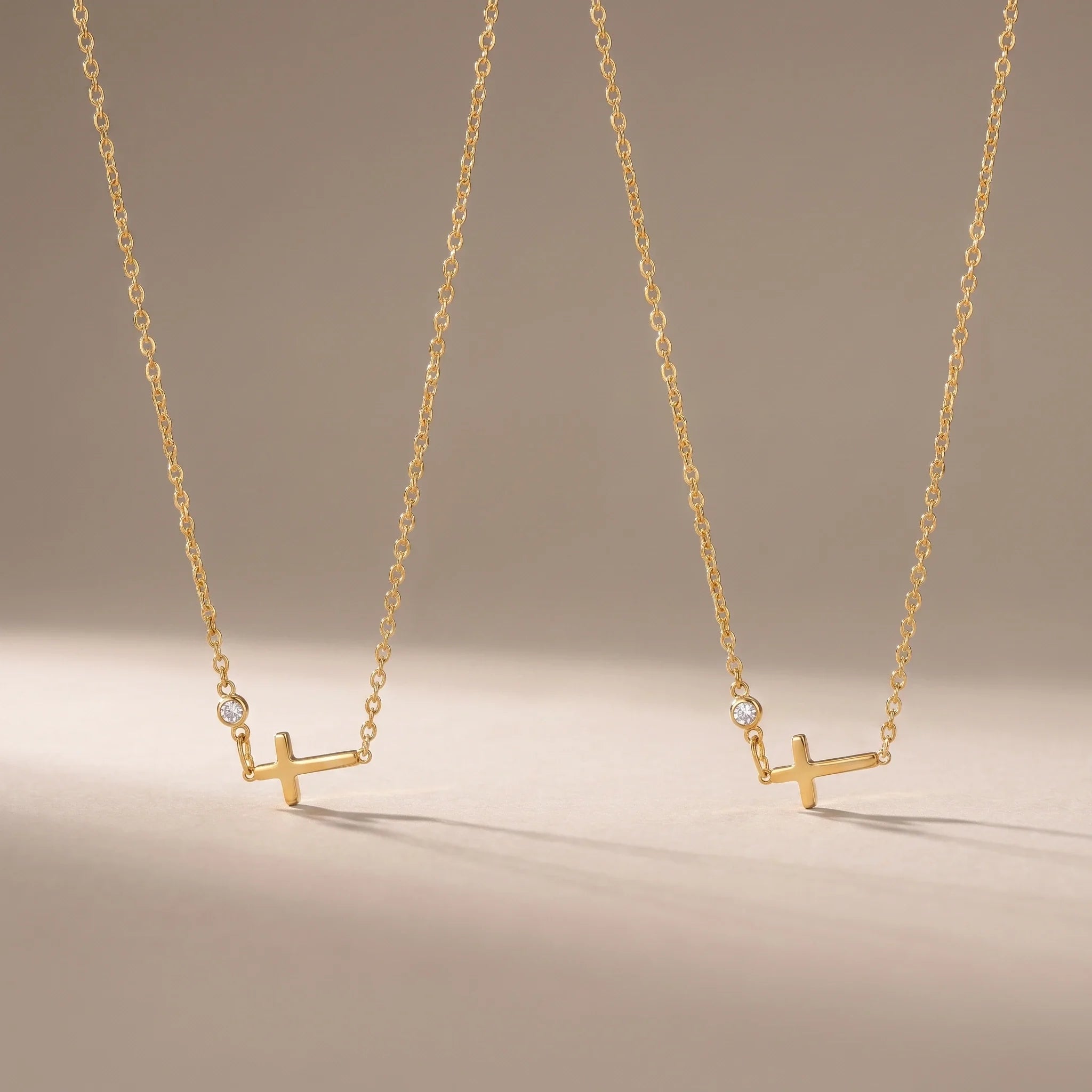 Sisters, two matching sealed 18K gold necklaces, on a plain background