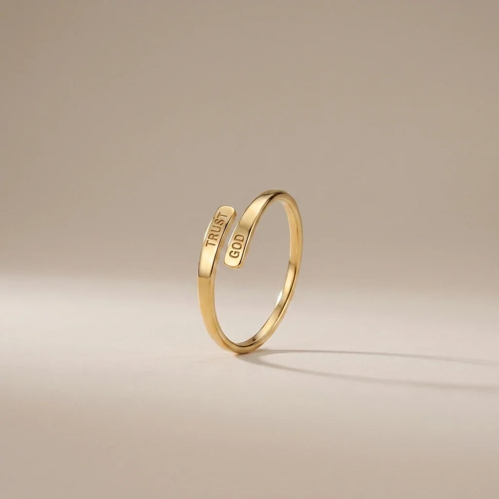 Trust God Ring, a sealed 18K gold engraved ring, on a plain background