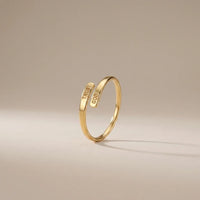 Trust God Ring, a sealed 18K gold engraved ring, on a plain background