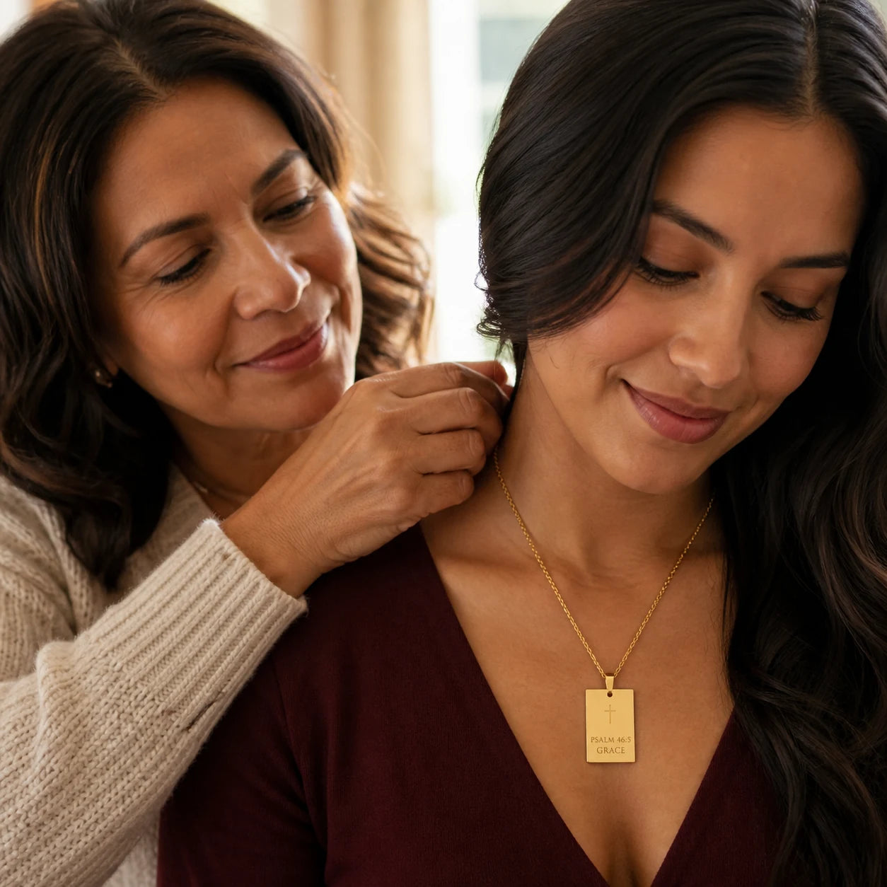 Mother giving a meaningful faith necklace to her daughter